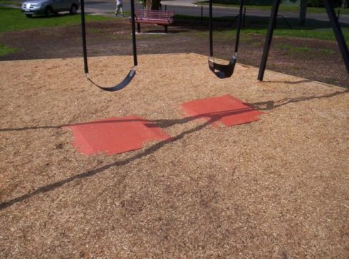 Rubber soft pads under play equipment fall zones